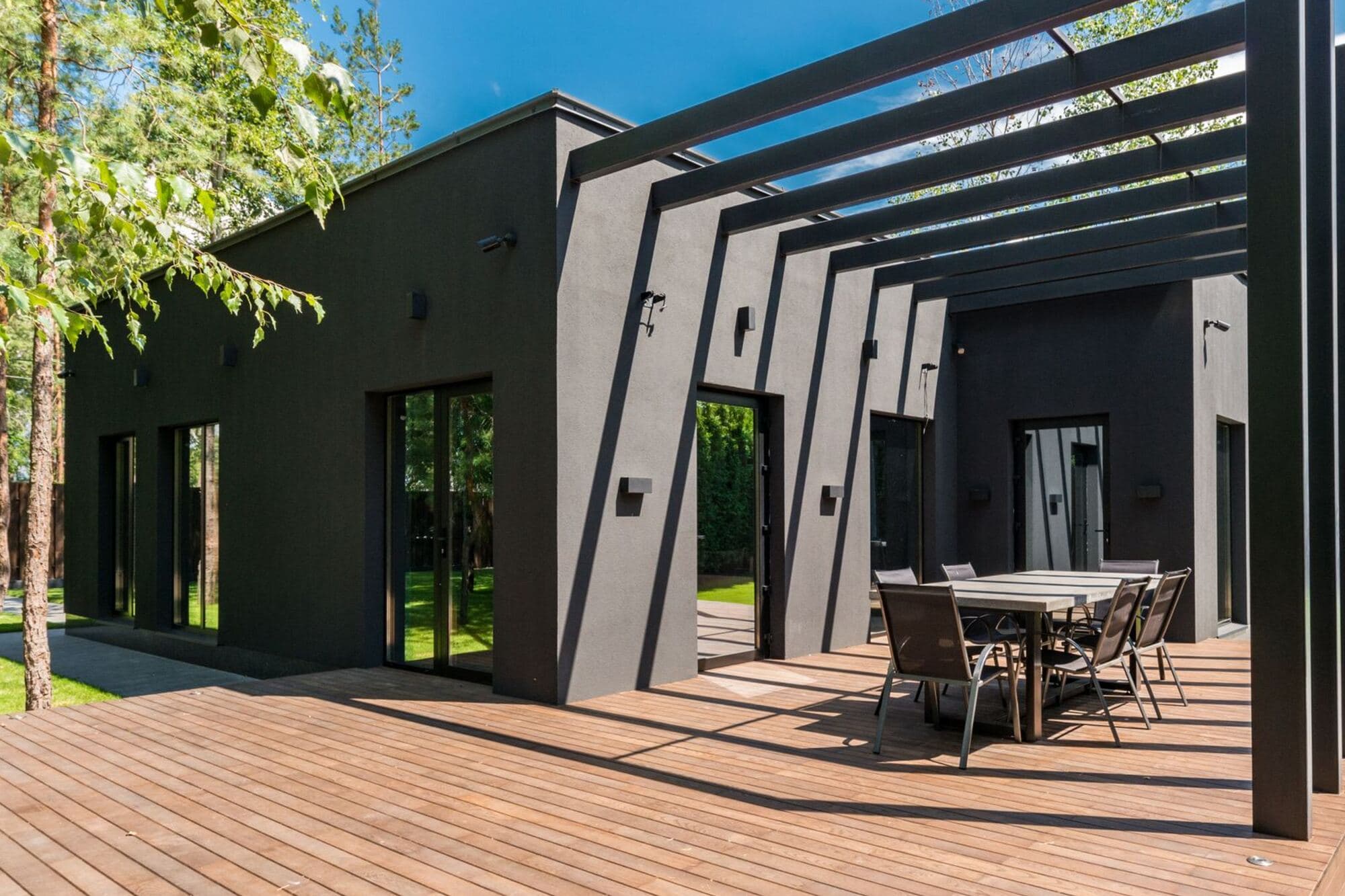 Wood deck and pergola off the back of a house