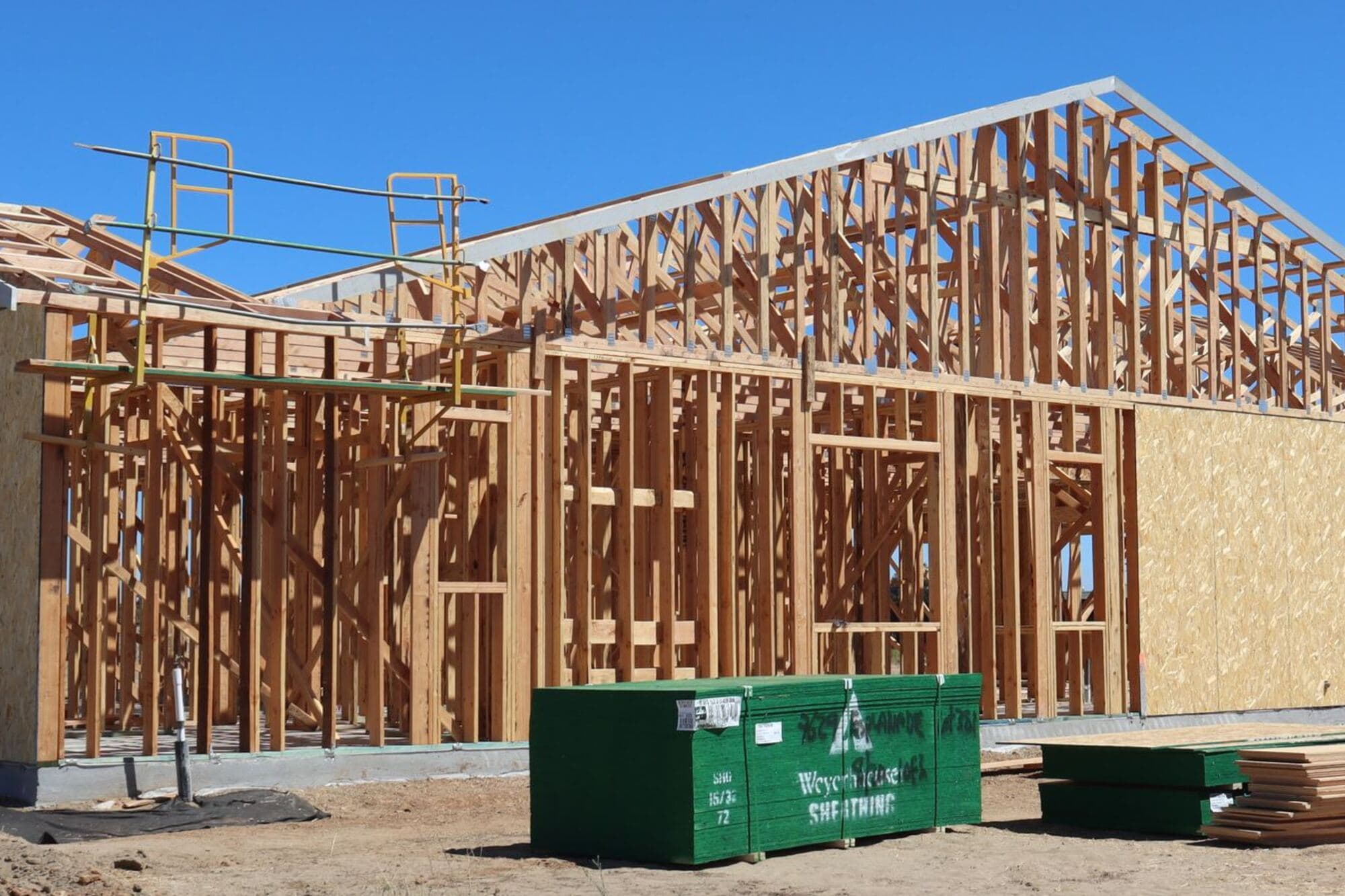 Wood-framed building going up on a cleared lot